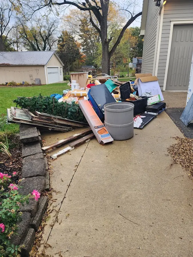 Dumpster being loaded with debris for Estate Cleanout Dumpster Rental in Hobbs